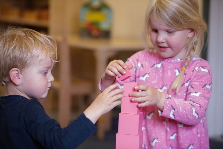 Boy and Girl Playing with Cubes in the Nursery Classroom