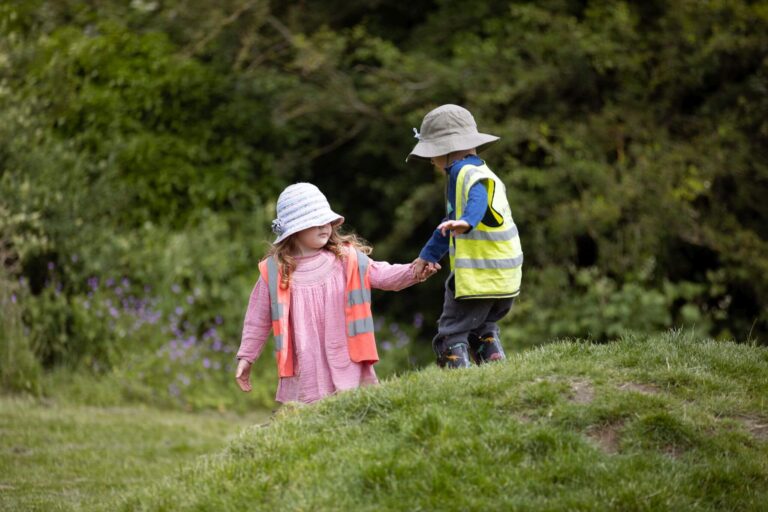 Little Boy and Girl Walking in the Forest Holding Hands