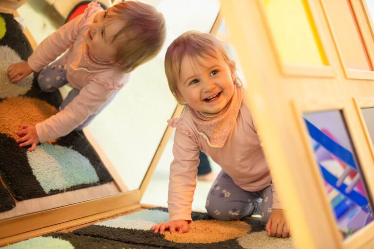Toddler Smiling While Crawling Through a Tunnel