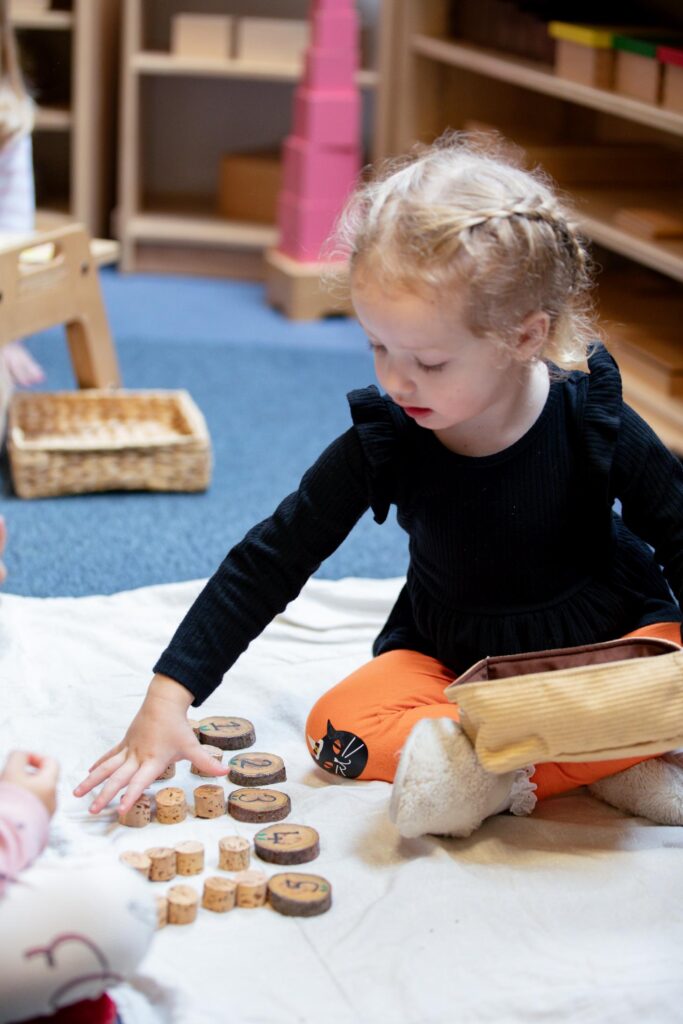 Child playing with educational number blocks indoors