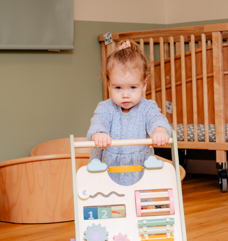 Child Using Wooden Activity Walker