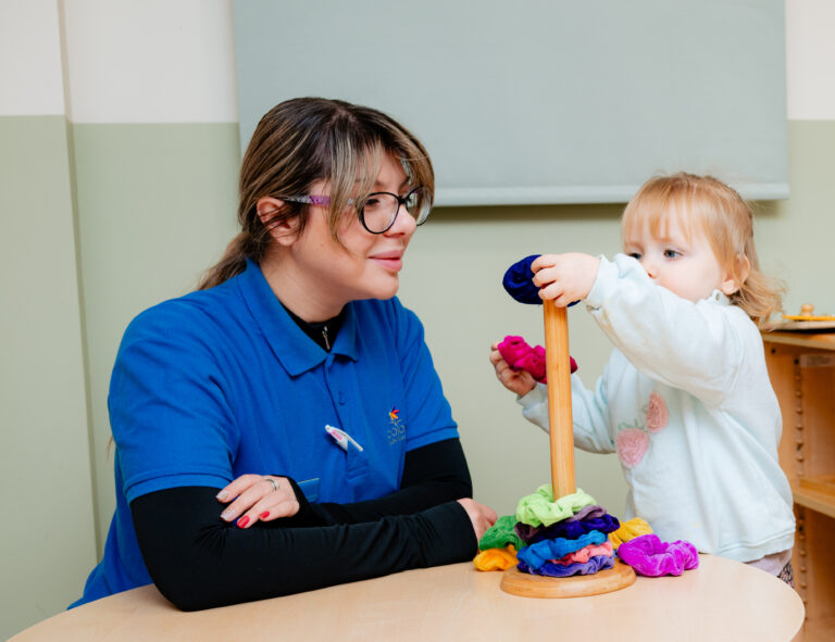 Child Developing Motor Skills with Stacking Toy