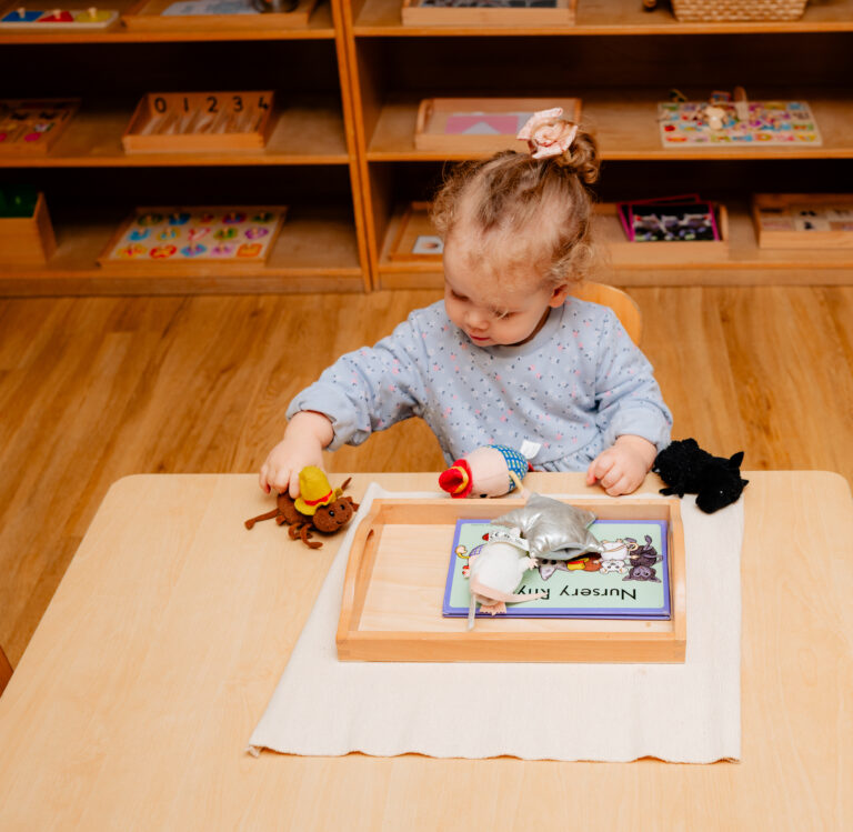 Child Playing with Soft Toy Animals in Nursery